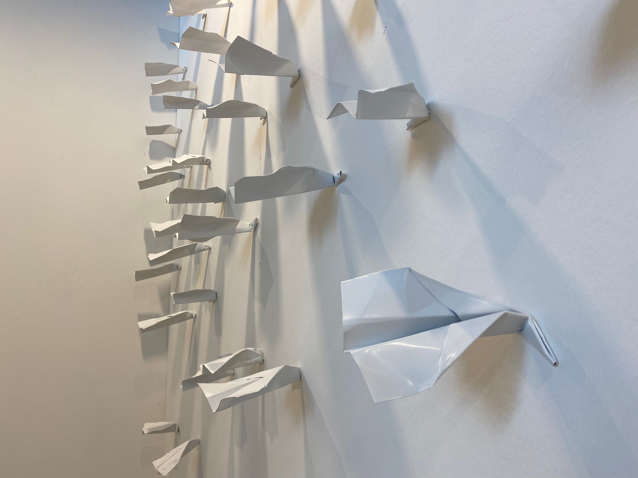 PAPER PLANES SIMULTANEOUSLY HITTING THE WALL